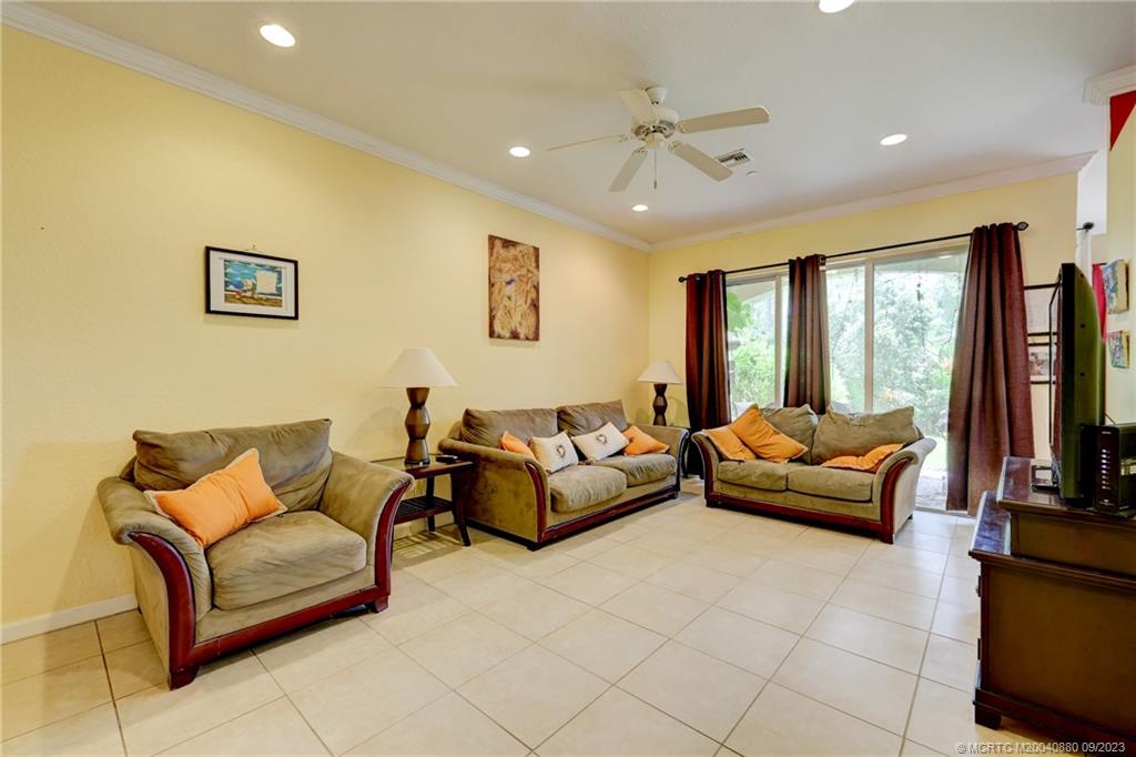 316 Southwest Otter Run Place Stuart, FL 34997 - Photo 13 of 50 a living room with furniture and a flat screen tv