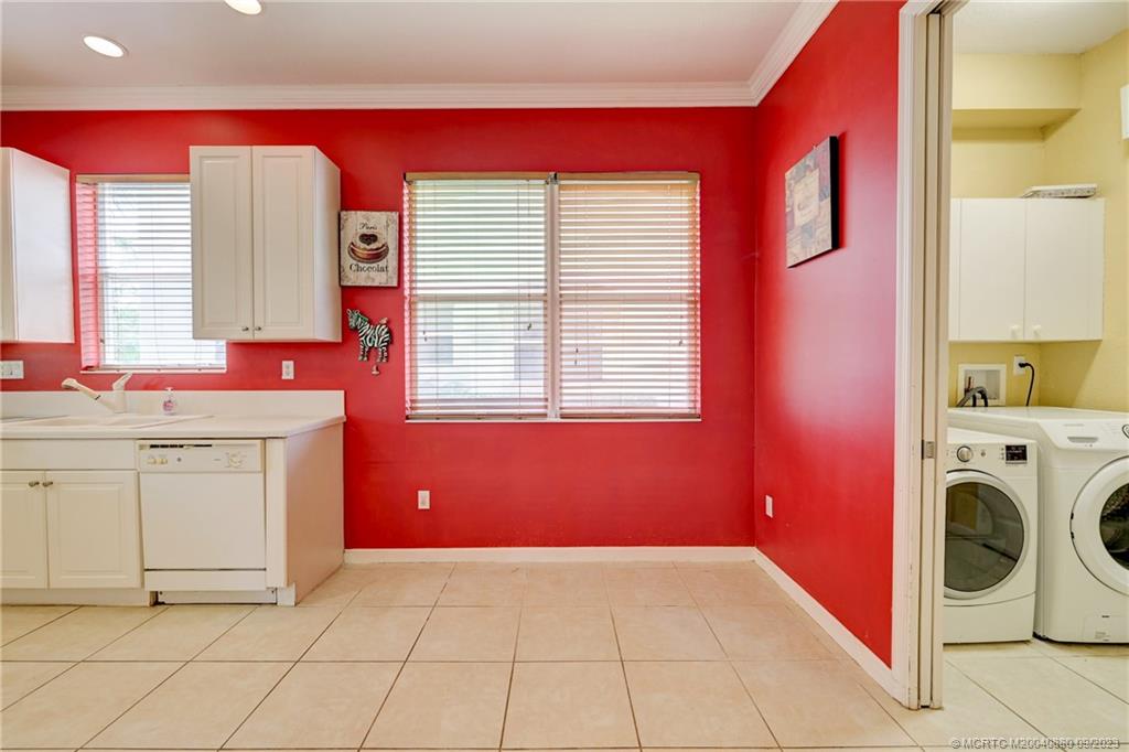 316 Southwest Otter Run Place Stuart, FL 34997 - Photo 14 of 50 a view of a kitchen with storage and utility