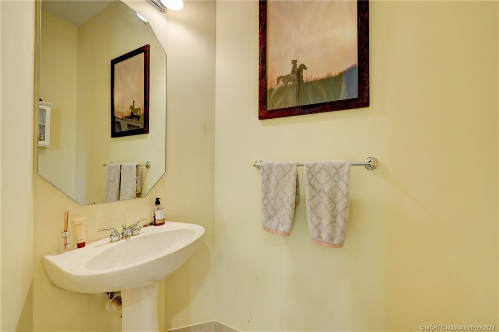 316 Southwest Otter Run Place Stuart, FL 34997 - Photo 17 of 50 a bathroom with a sink and mirror