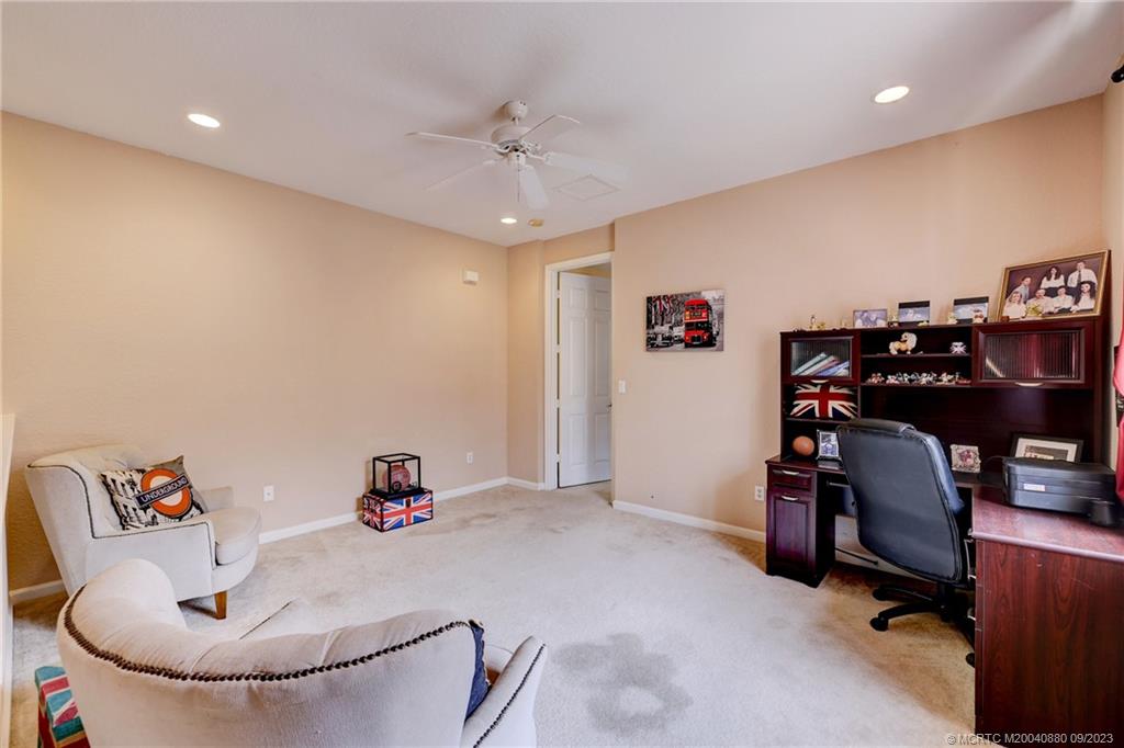 316 Southwest Otter Run Place Stuart, FL 34997 - Photo 19 of 50 a workspace with furniture and ceiling fan
