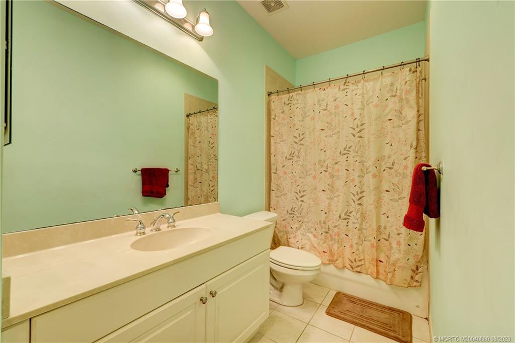 316 Southwest Otter Run Place Stuart, FL 34997 - Photo 30 of 50 a bathroom with a sink and a mirror