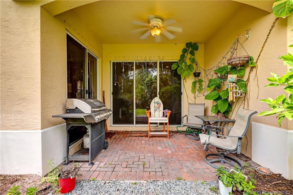 316 Southwest Otter Run Place Stuart, FL 34997 - Photo 31 of 50 a living room with patio furniture and a potted plant