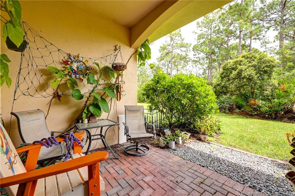 316 Southwest Otter Run Place Stuart, FL 34997 - Photo 32 of 50 a view of a balcony with chairs and a table