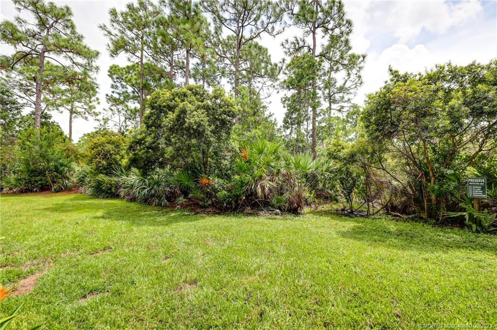 316 Southwest Otter Run Place Stuart, FL 34997 - Photo 33 of 50 a view of a grassy field with trees in the background