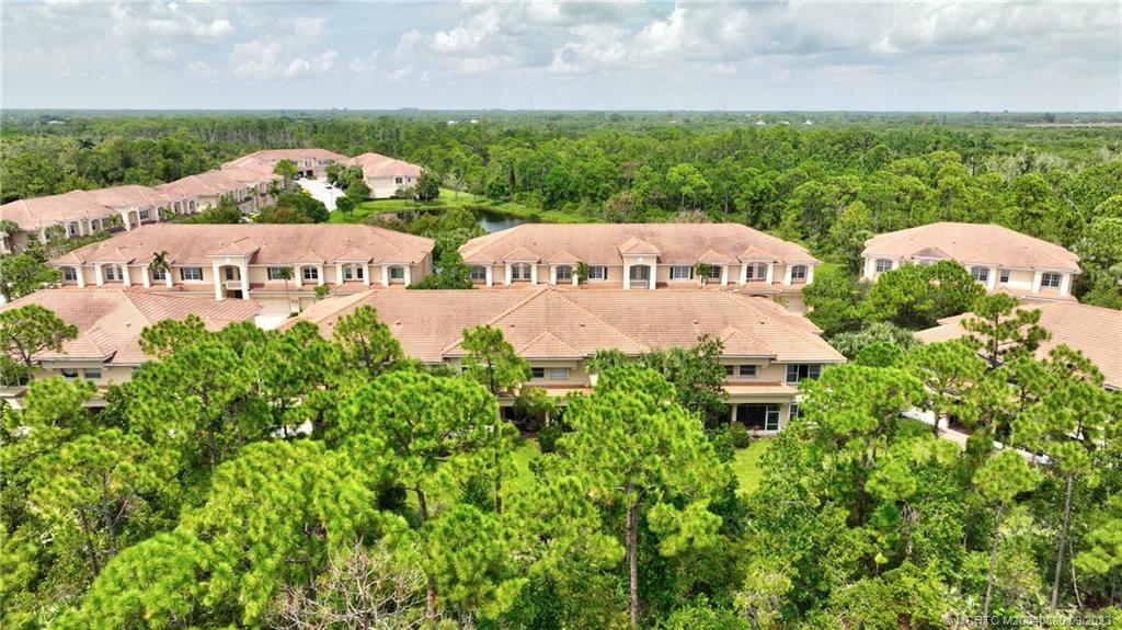 316 Southwest Otter Run Place Stuart, FL 34997 - Photo 48 of 50 an aerial view of a house with yard and outdoor seating