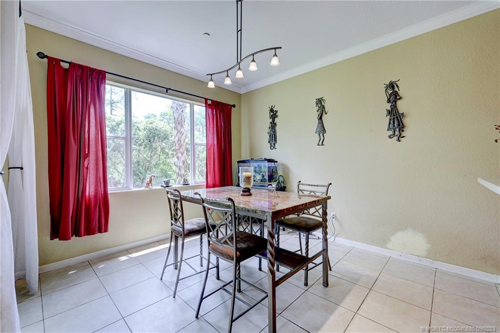 316 Southwest Otter Run Place Stuart, FL 34997 - Photo 5 of 50 a view of a dining room with furniture window and outside view