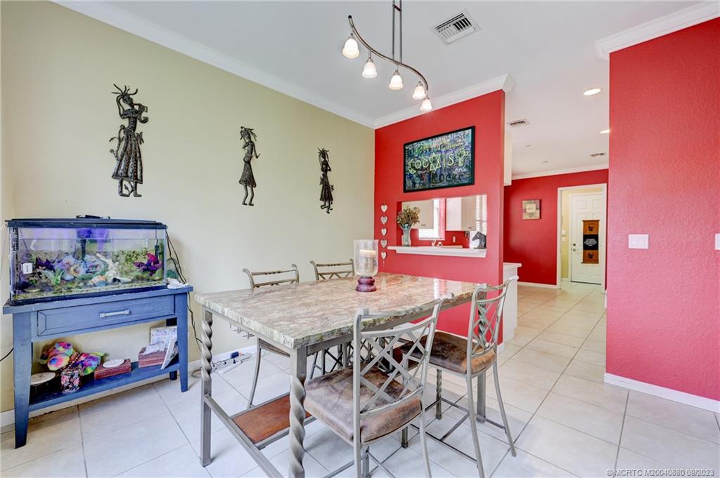 316 Southwest Otter Run Place Stuart, FL 34997 - Photo 6 of 50 a dining room with a table and chairs