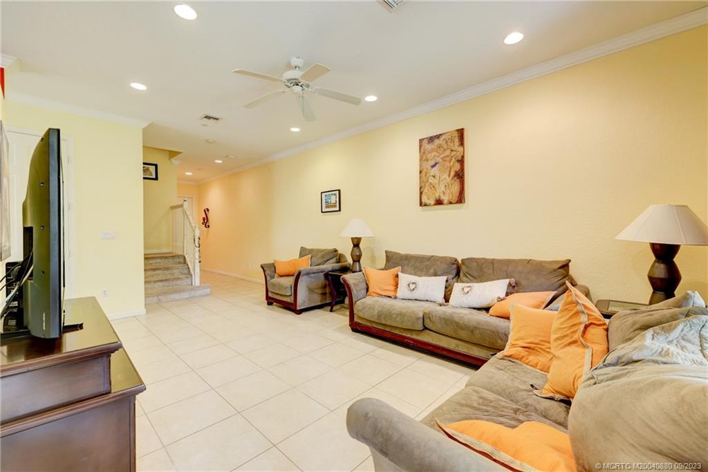 316 Southwest Otter Run Place Stuart, FL 34997 - Photo 10 of 50 a living room with furniture and a flat screen tv