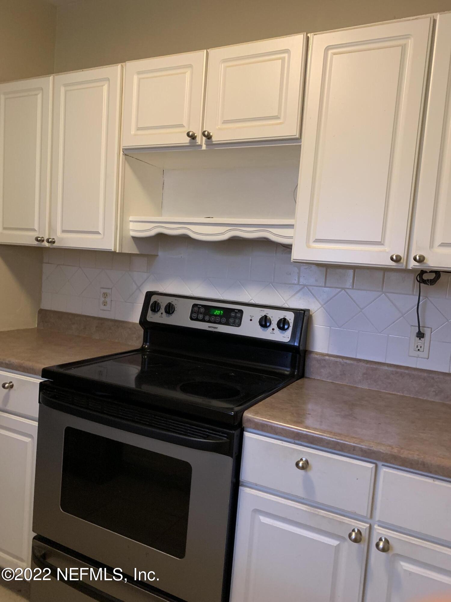 7014 Rollo Road Jacksonville, FL 32205 - Photo 17 of 21 a stove top oven sitting inside of a kitchen