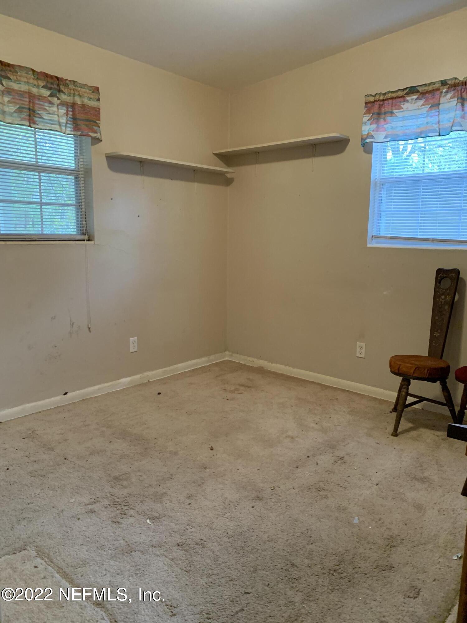 7014 Rollo Road Jacksonville, FL 32205 - Photo 9 of 21 a room with a desk and a chair