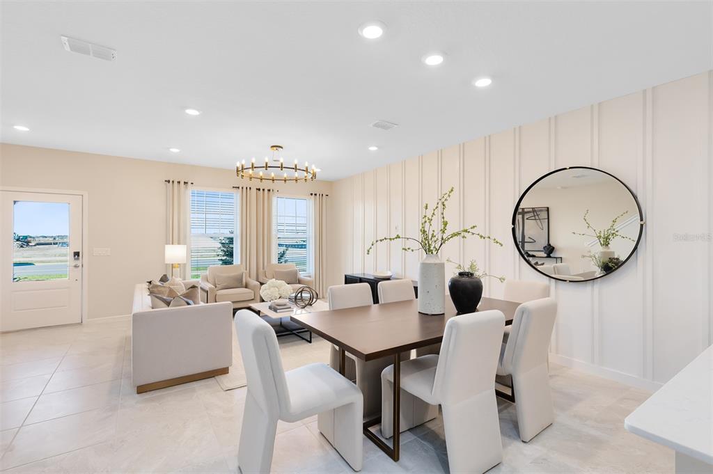 11483 Harborview Street Orlando, FL 32832 - Photo 11 of 26 a dining room with wooden floor a chandelier a wooden table and chairs