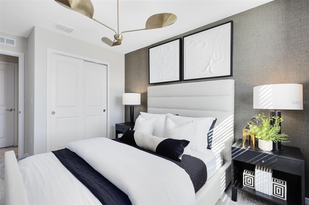 11483 Harborview Street Orlando, FL 32832 - Photo 21 of 26 a bedroom with a bed and a lamp on the dresser