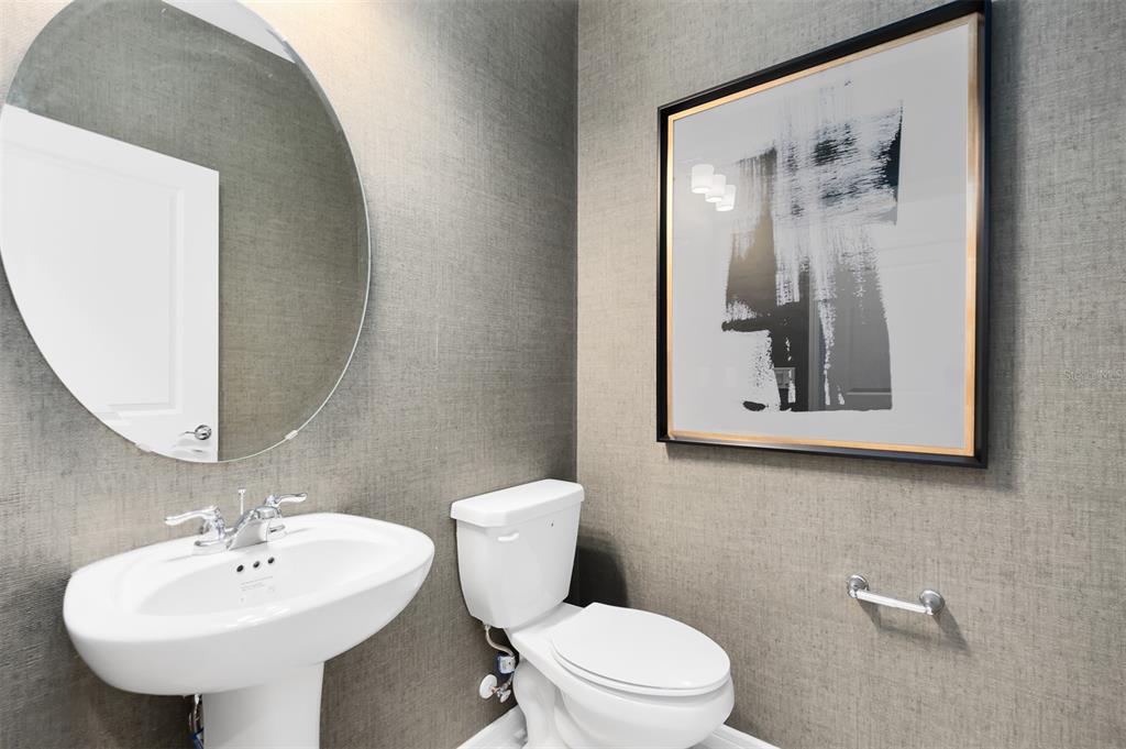 11483 Harborview Street Orlando, FL 32832 - Photo 24 of 26 a bathroom with a toilet sink and mirror