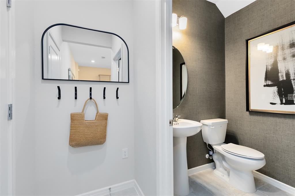 11483 Harborview Street Orlando, FL 32832 - Photo 25 of 26 a white toilet sitting next to a bathroom sink