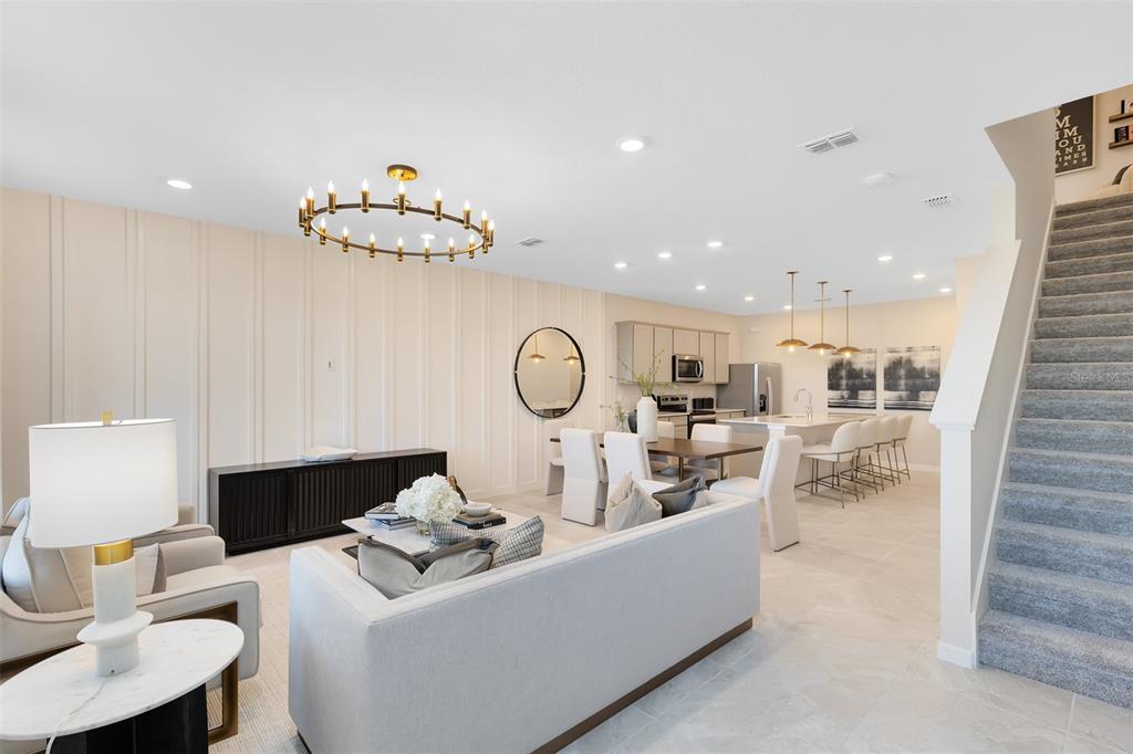 11483 Harborview Street Orlando, FL 32832 - Photo 4 of 26 a living room with furniture a table and chairs