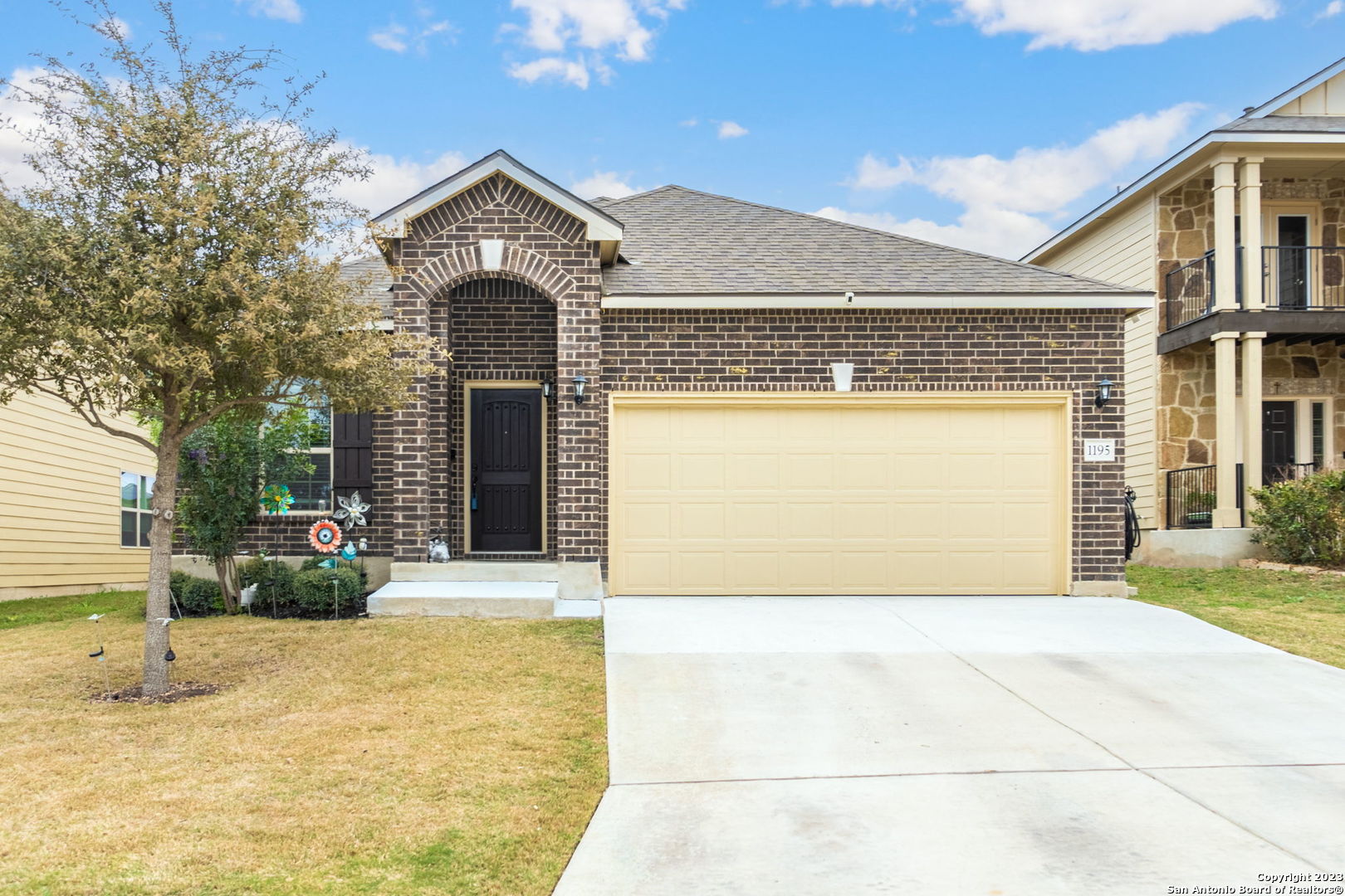 1195 Ranch Falls San Antonio, TX 78245 - Photo 1 of 1 a front view of a house with a garden