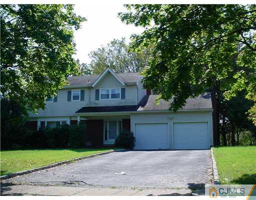 3 Baltic Street Edison, NJ 08820 - Photo 15 of 16 a front view of a house with a garden and trees