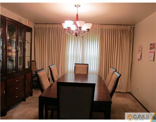 3 Baltic Street Edison, NJ 08820 - Photo 3 of 16 a view of a dining room with furniture and a chandelier