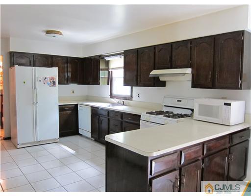 3 Baltic Street Edison, NJ 08820 - Photo 4 of 16 a kitchen with a stove a refrigerator and a sink