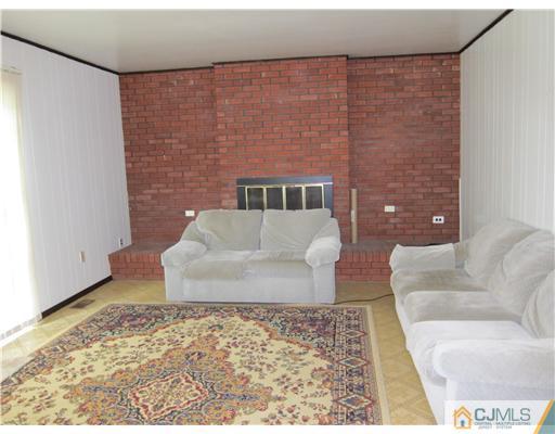 3 Baltic Street Edison, NJ 08820 - Photo 6 of 16 a living room with a couch and a coffee table