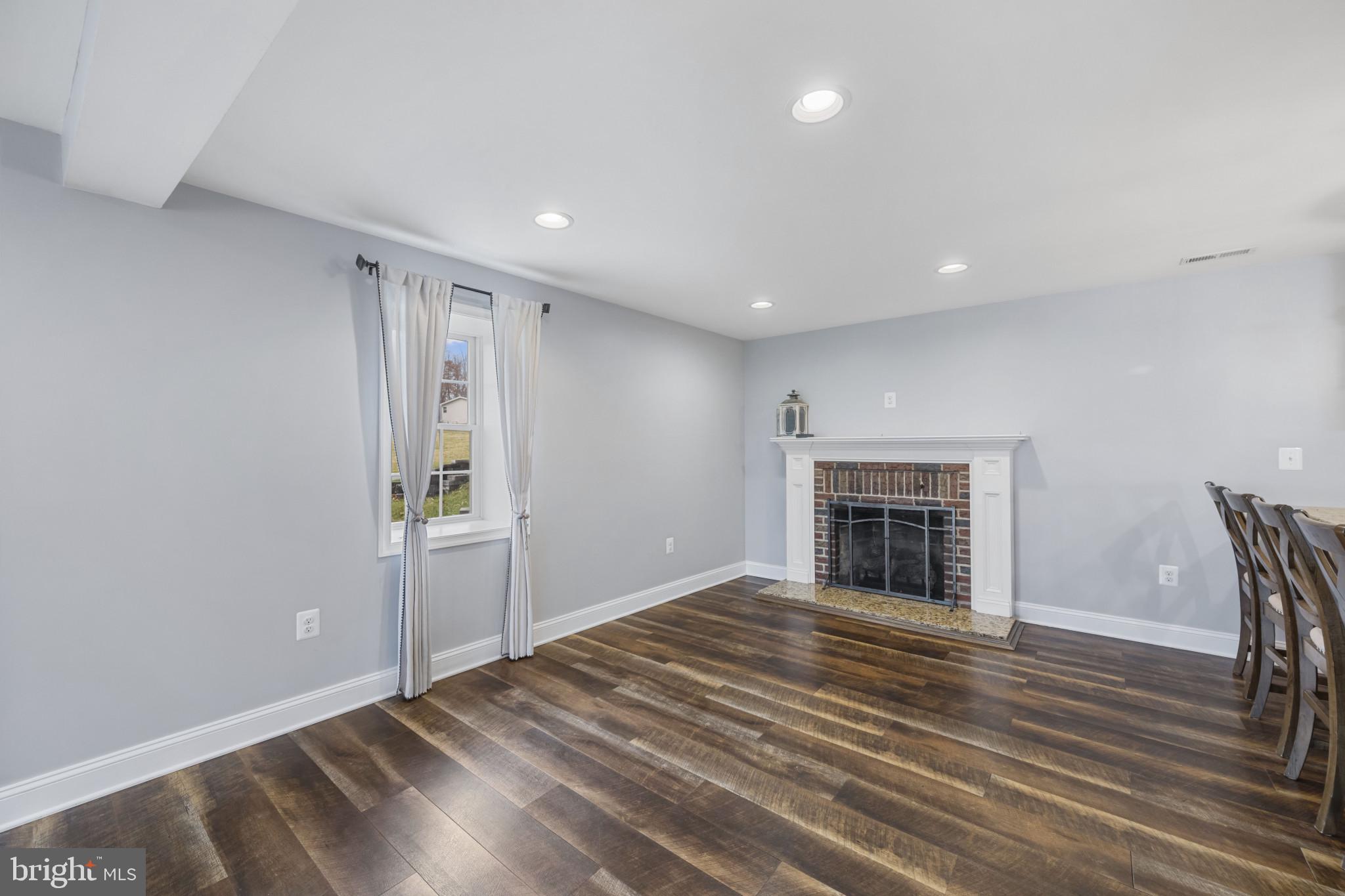 35 South Mcdermott Road, Unit A Pylesville, MD 21132 - Photo 13 of 35 a view of an empty room with wooden floor and a window
