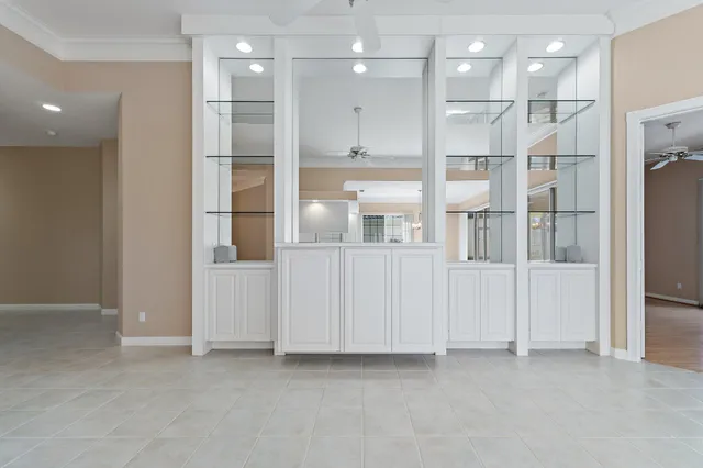 a view of a room with shelves and a ceiling fan