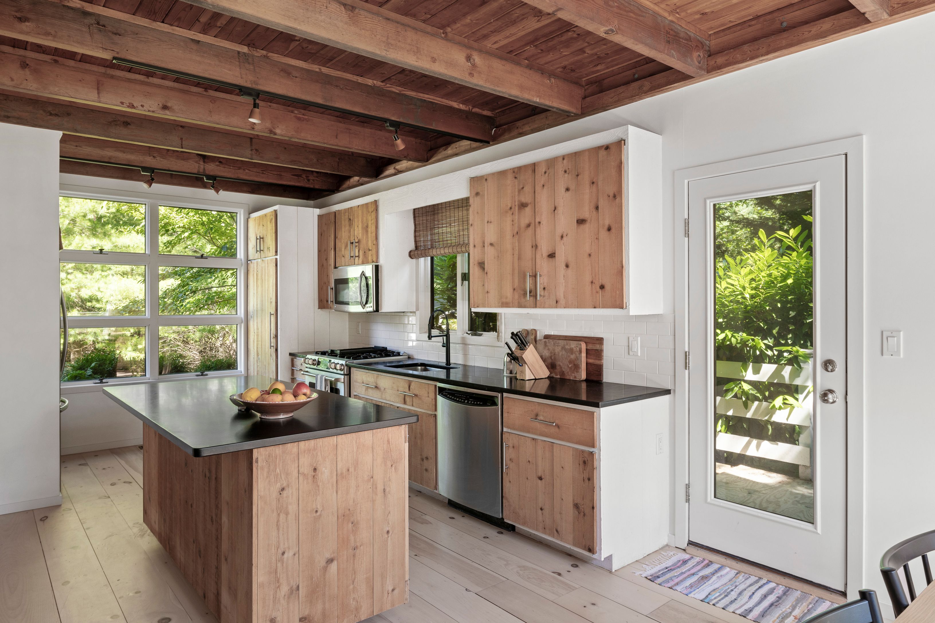 97 Swamp Road East Hampton, NY 11937 - Photo 11 of 28 a kitchen with sink a stove and wooden cabinets