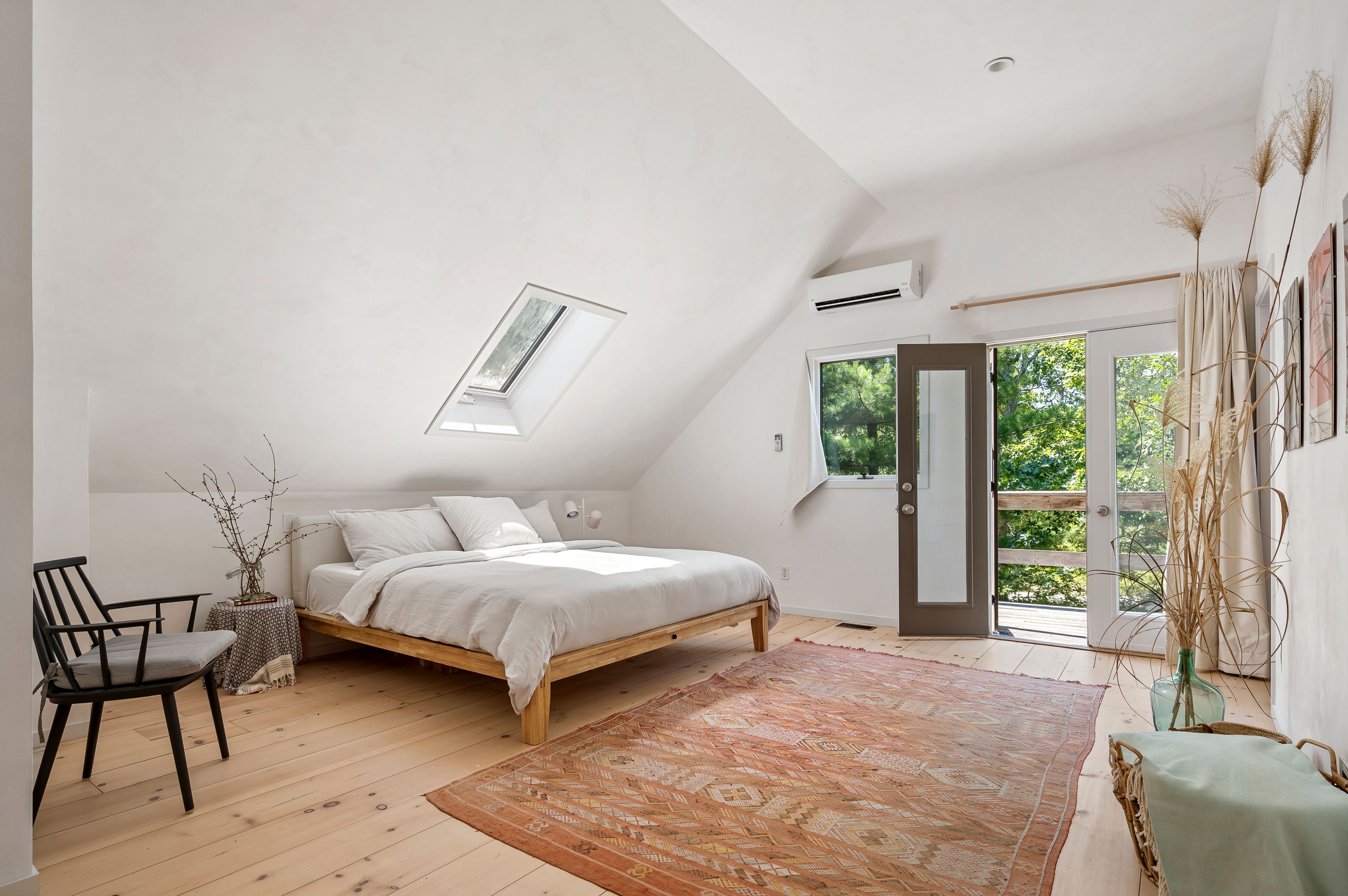 97 Swamp Road East Hampton, NY 11937 - Photo 16 of 28 a bedroom with a bed chair and window