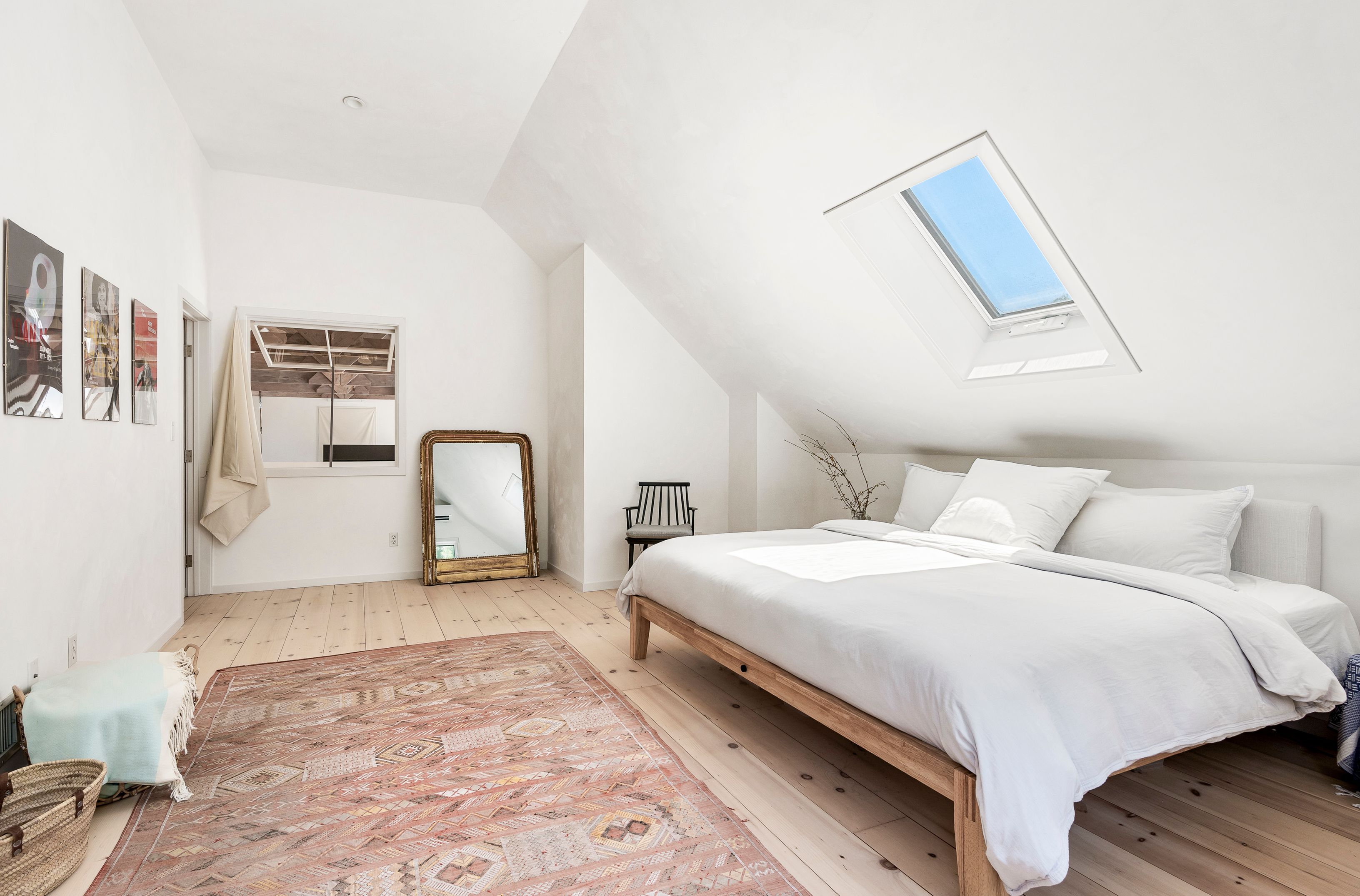 97 Swamp Road East Hampton, NY 11937 - Photo 17 of 28 a bedroom with a bed and a mirror