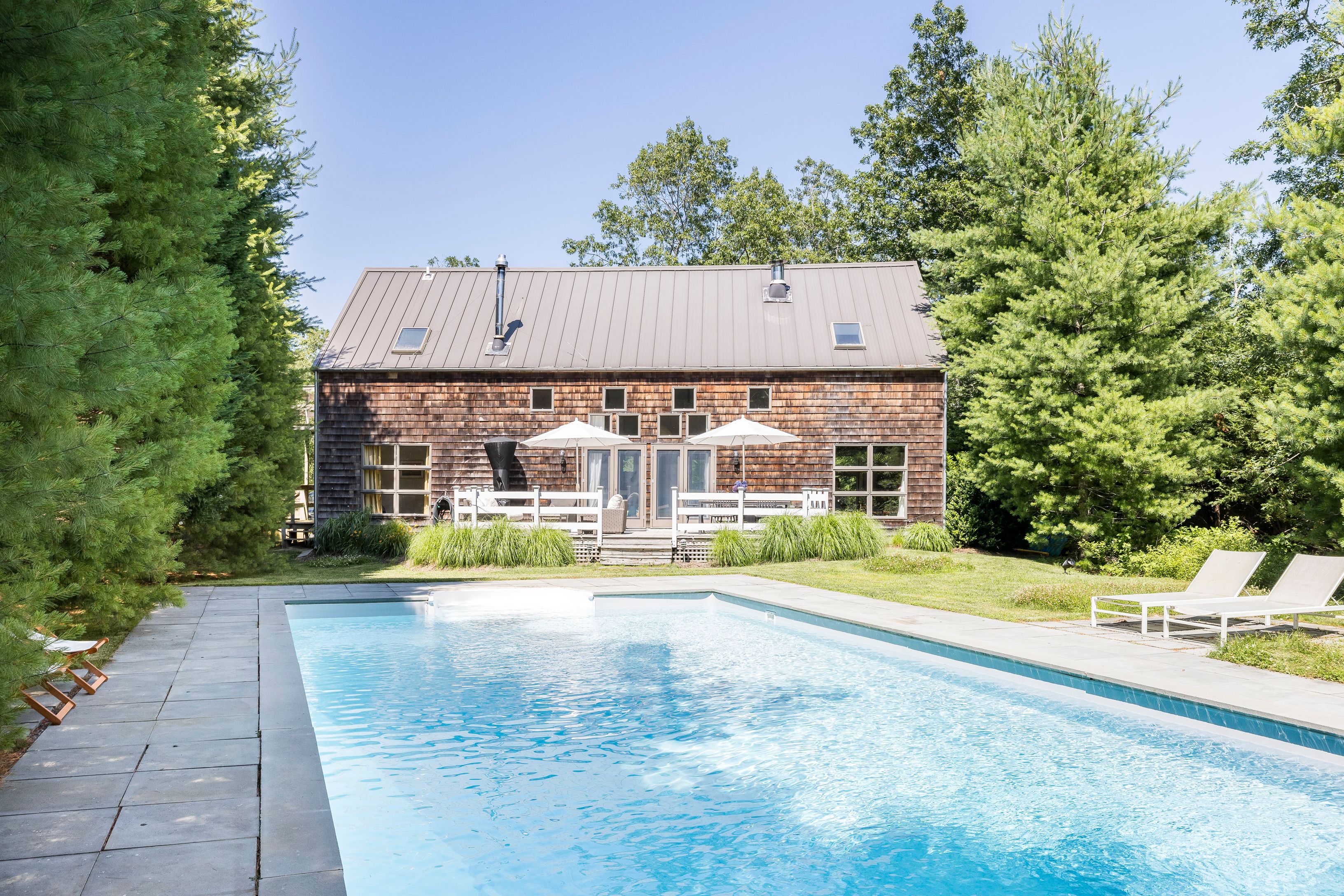 97 Swamp Road East Hampton, NY 11937 - Photo 2 of 28 a view of a house with a yard and sitting area