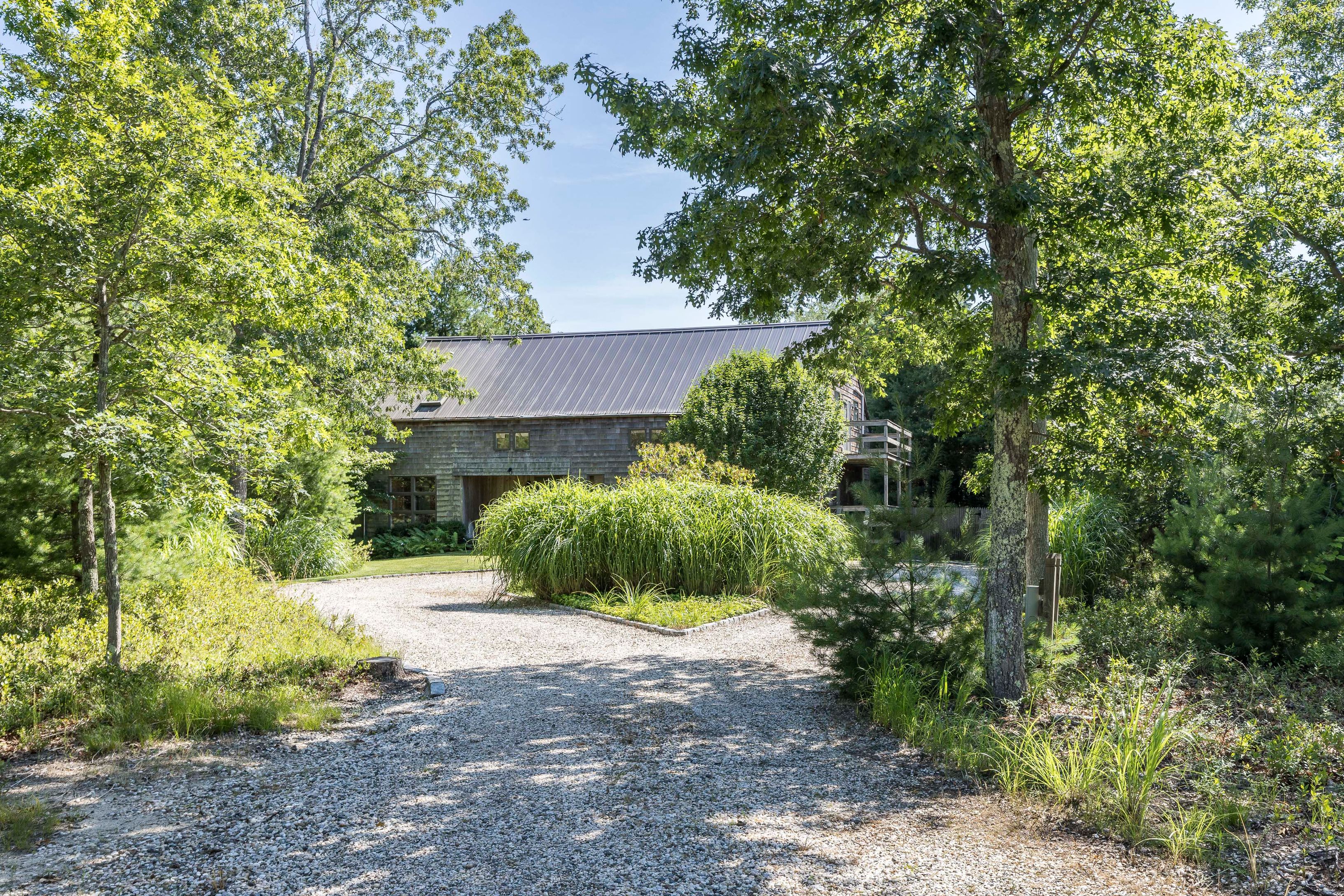 97 Swamp Road East Hampton, NY 11937 - Photo 26 of 28 a front view of a house with a yard and garage
