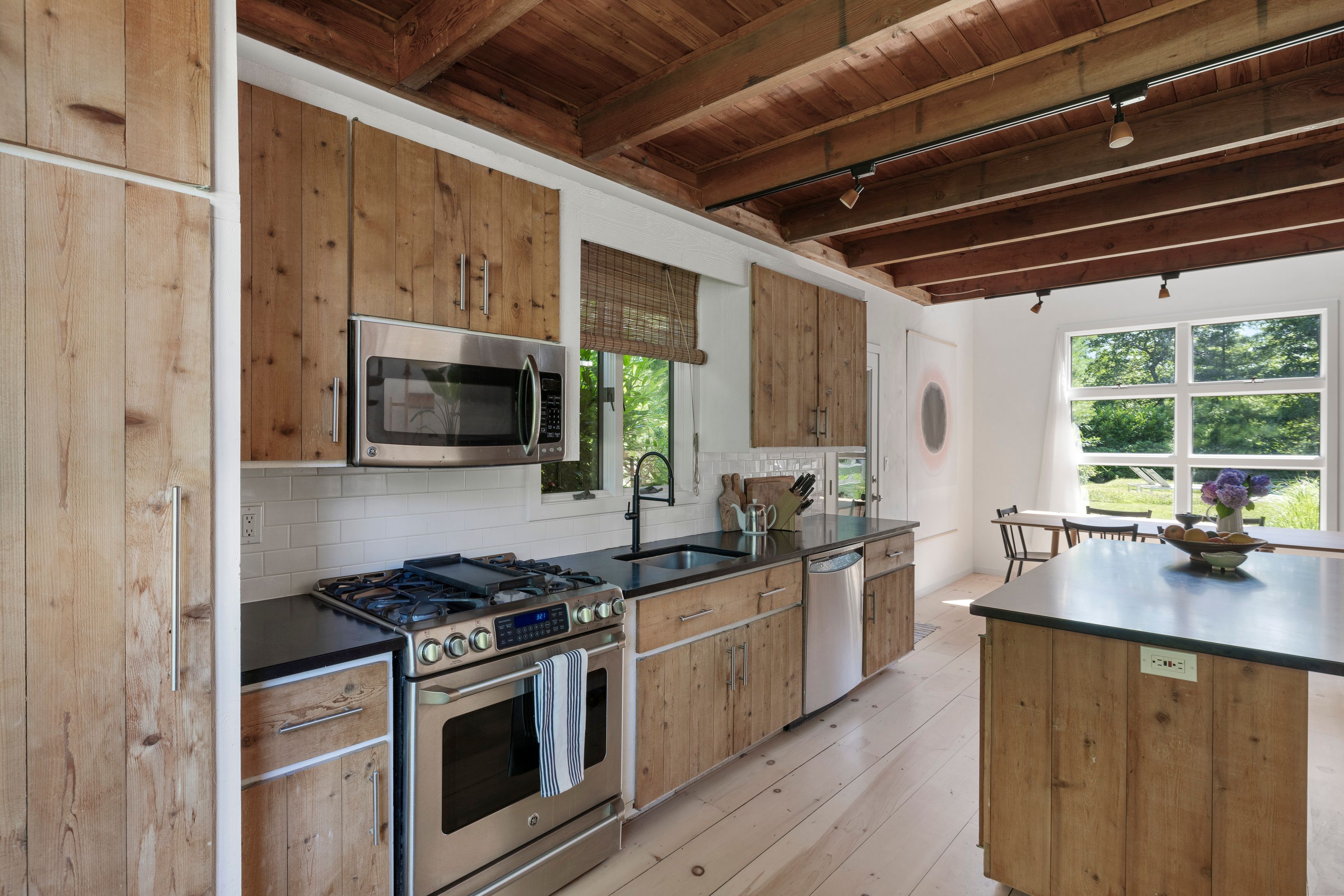 97 Swamp Road East Hampton, NY 11937 - Photo 10 of 28 a kitchen with stainless steel appliances a stove a sink and a microwave