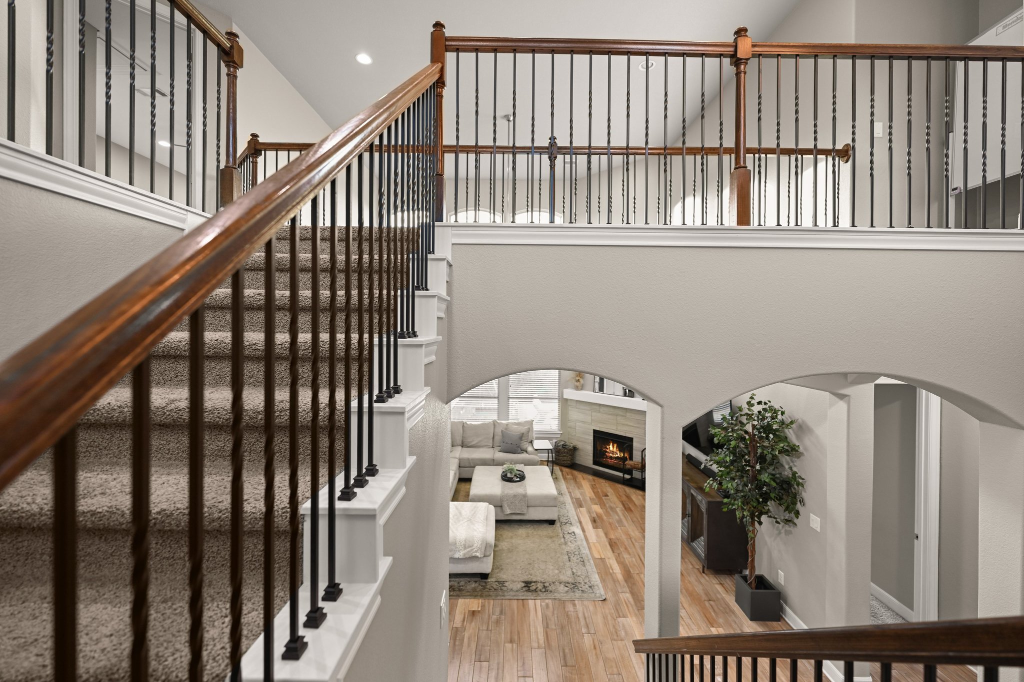 22524 Rock Wren Road Spicewood, TX 78669 - Photo 22 of 40 Multilevel interior featuring a carpeted staircase with wood banister and wrought iron balusters