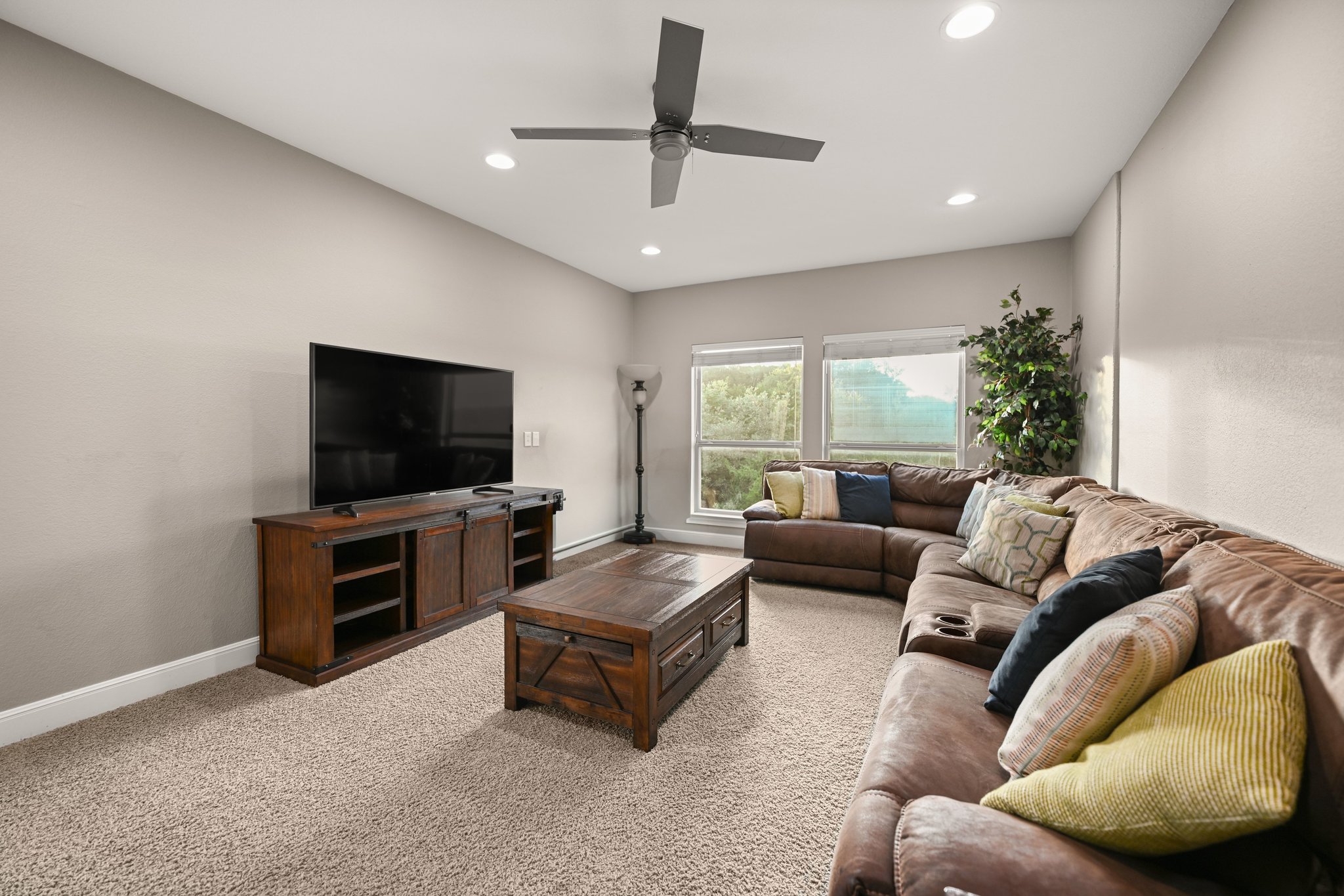 22524 Rock Wren Road Spicewood, TX 78669 - Photo 26 of 40 Living area featuring carpet flooring, recessed lighting, and a ceiling fan