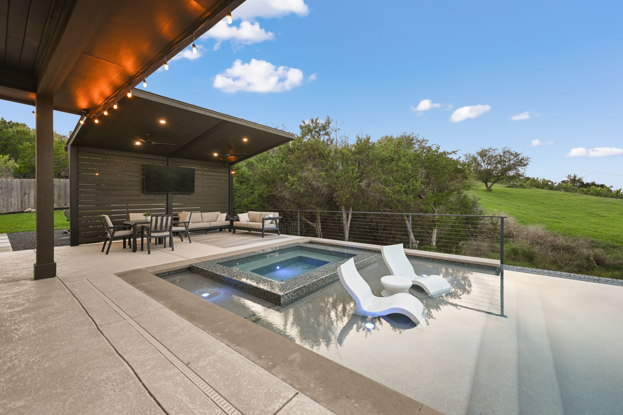 22524 Rock Wren Road Spicewood, TX 78669 - Photo 30 of 40 Outdoor living area featuring a covered patio, built-in hot tub, and an integrated pool
