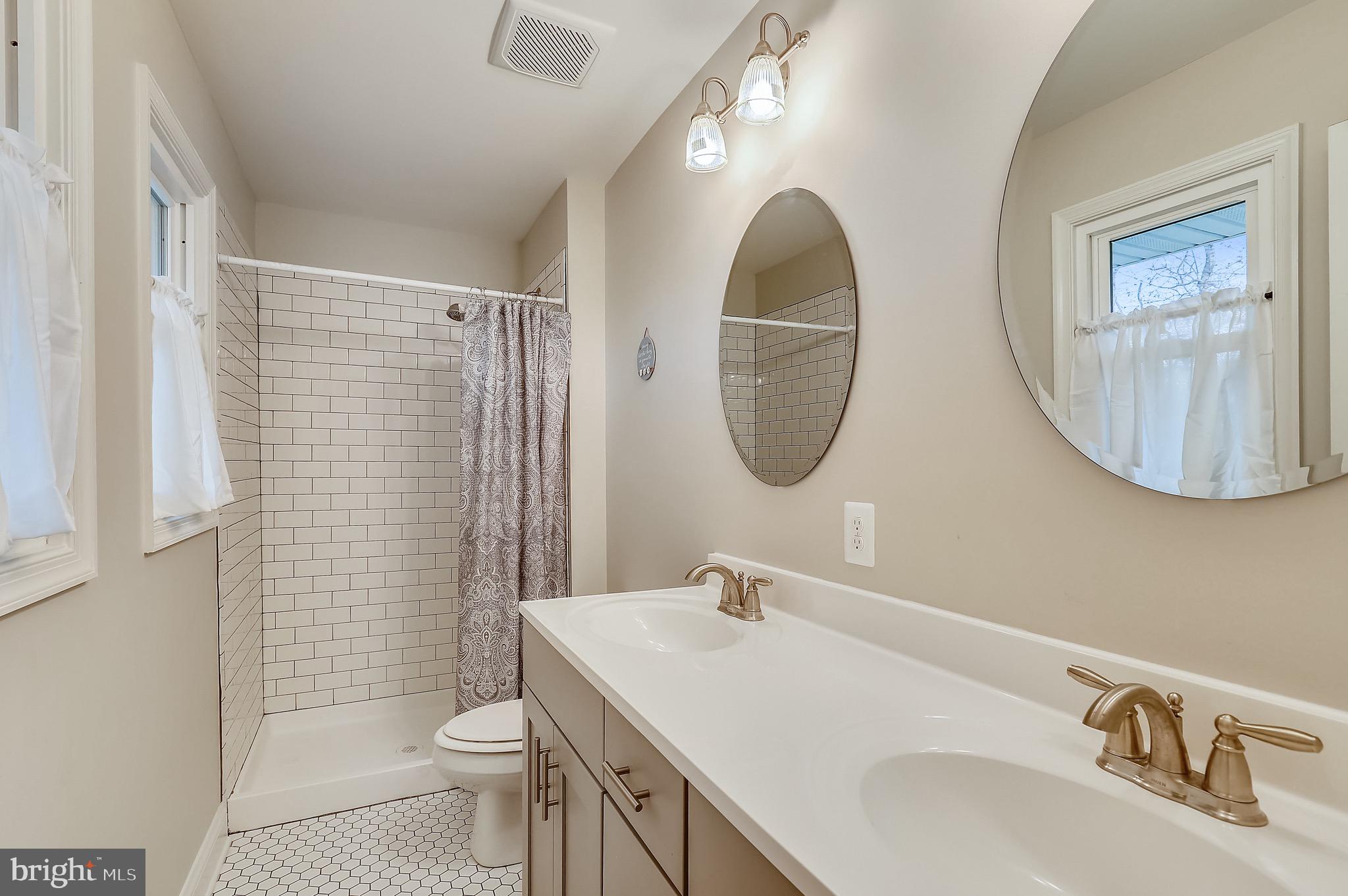 9426 Boyds Turn Road Owings, MD 20736 - Photo 18 of 27 a bathroom with a sink a toilet and a mirror