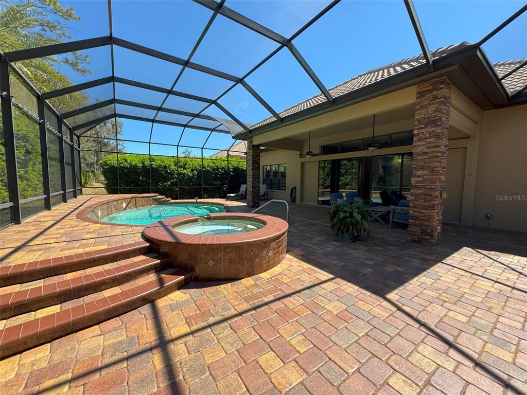 1024 West Beagle Run Loop Hernando, FL 34442 - Photo 37 of 44 a view of a backyard with table and chairs under an umbrella