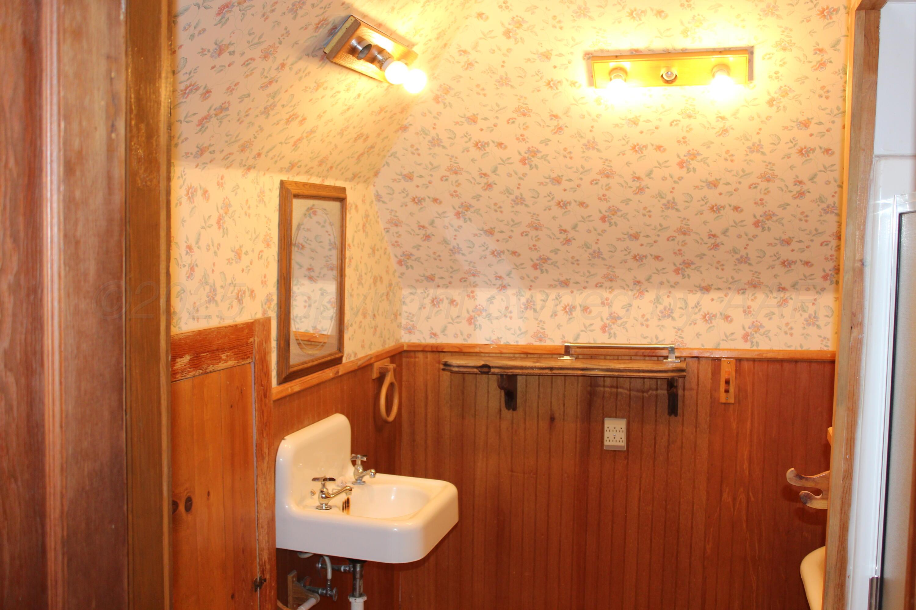 14330 Broome Road Memphis, TX 79245 - Photo 22 of 63 a bathroom with a sink mirror and vanity