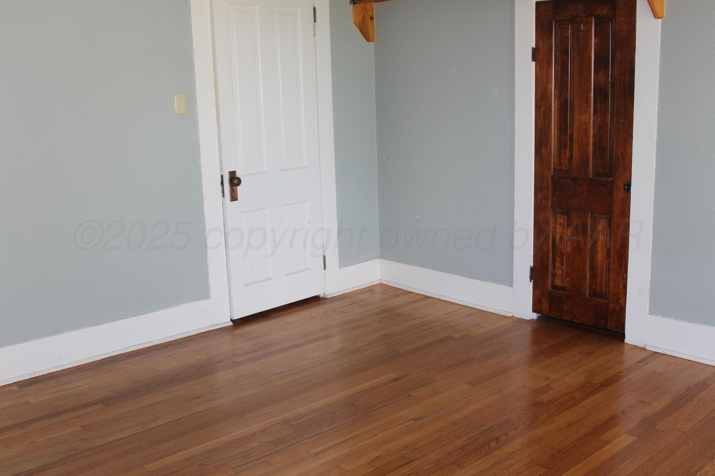 14330 Broome Road Memphis, TX 79245 - Photo 26 of 63 a view of an empty room with wooden floor and closet