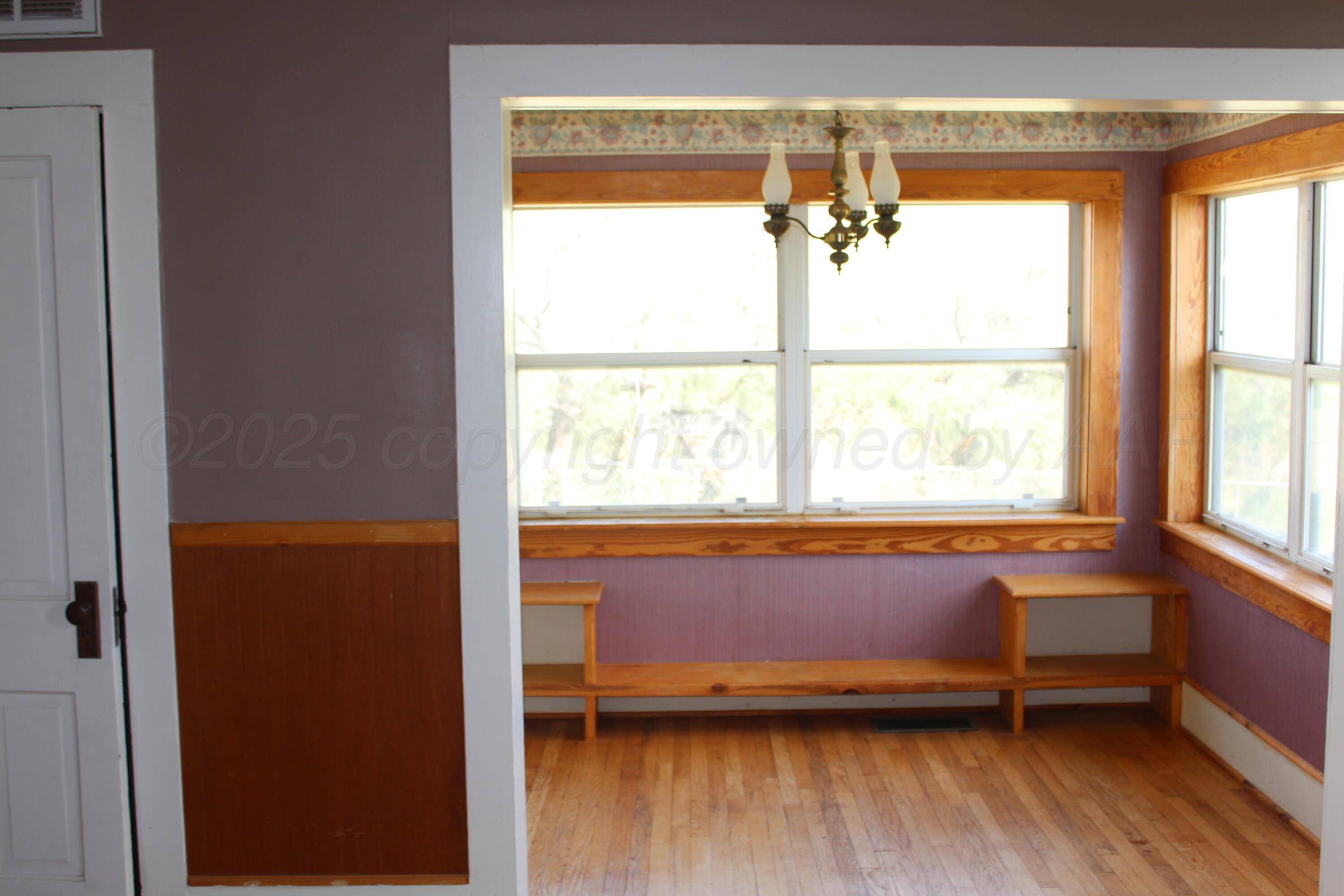 14330 Broome Road Memphis, TX 79245 - Photo 33 of 63 a living room with a large window and wooden floor