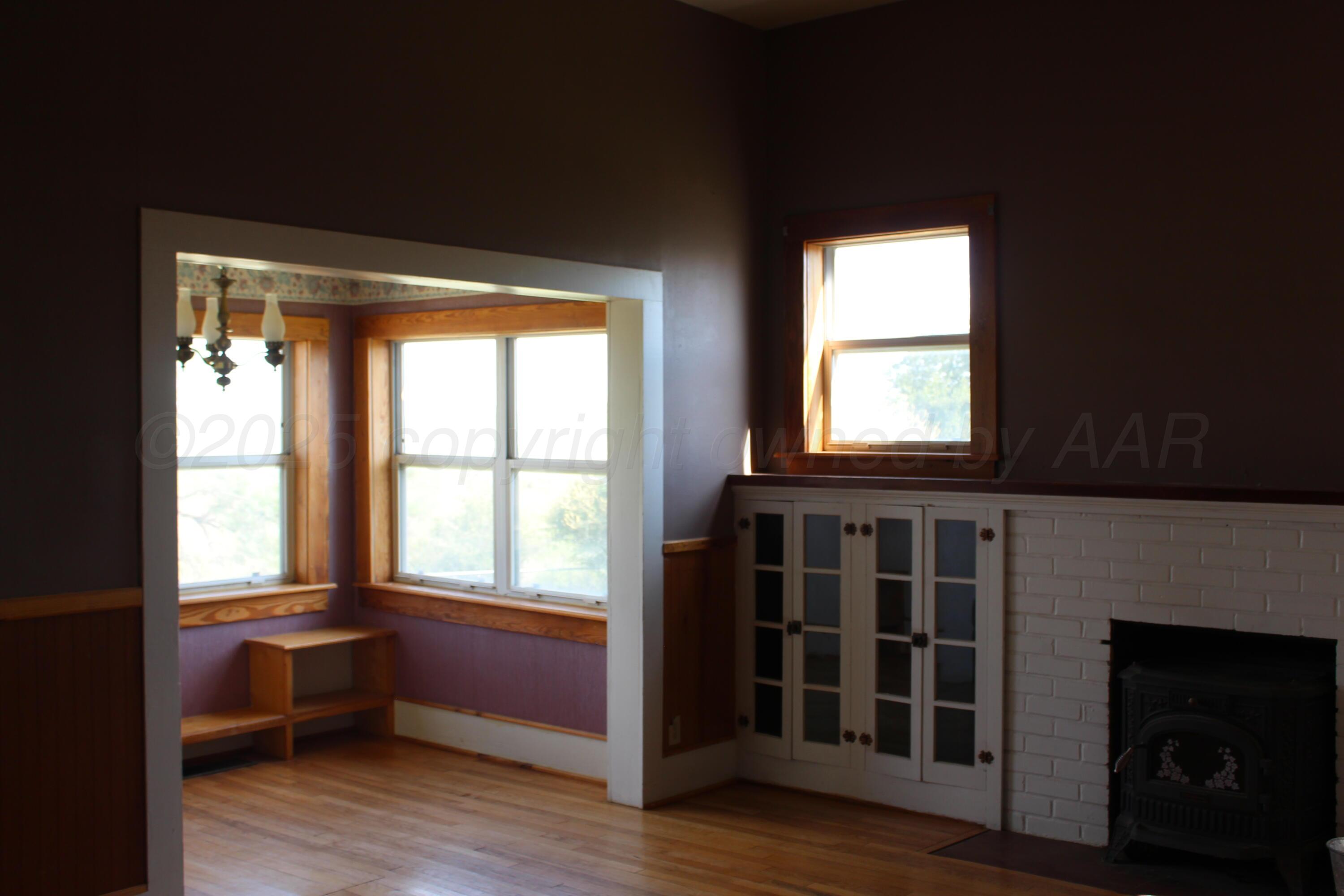 14330 Broome Road Memphis, TX 79245 - Photo 35 of 63 a view of an empty room with wooden floor and a window