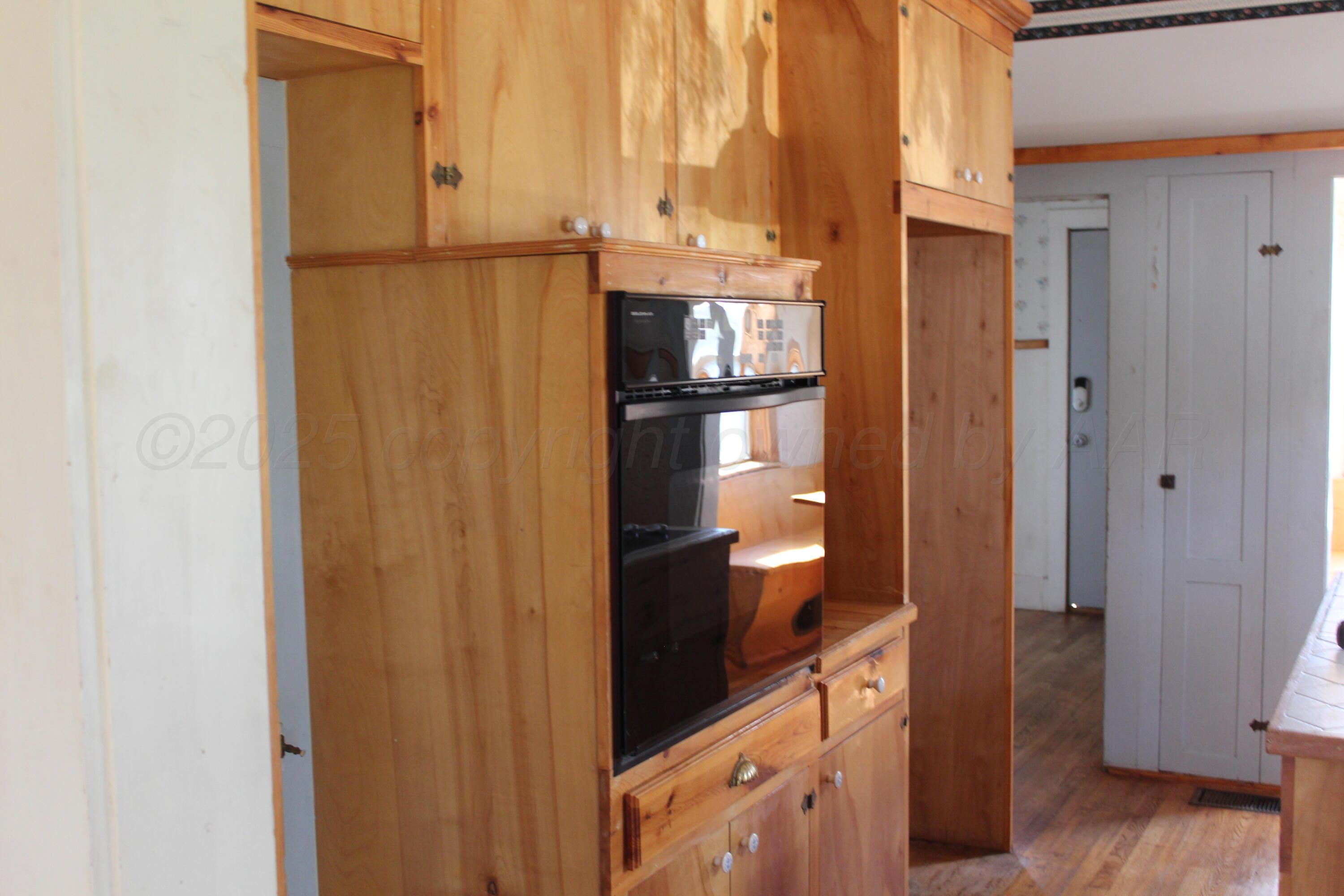 14330 Broome Road Memphis, TX 79245 - Photo 40 of 63 a walk in closet with wooden floor
