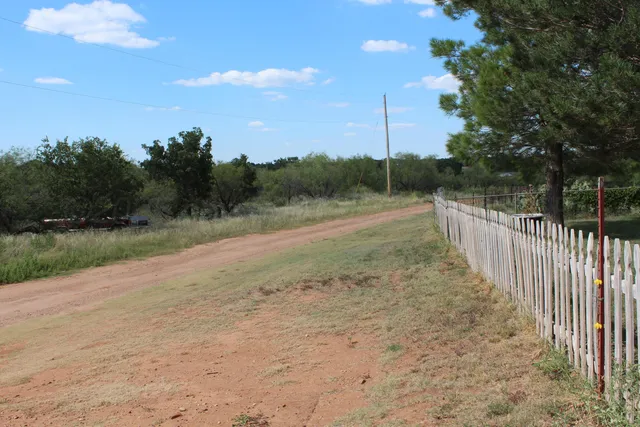 a view of a road with a yard