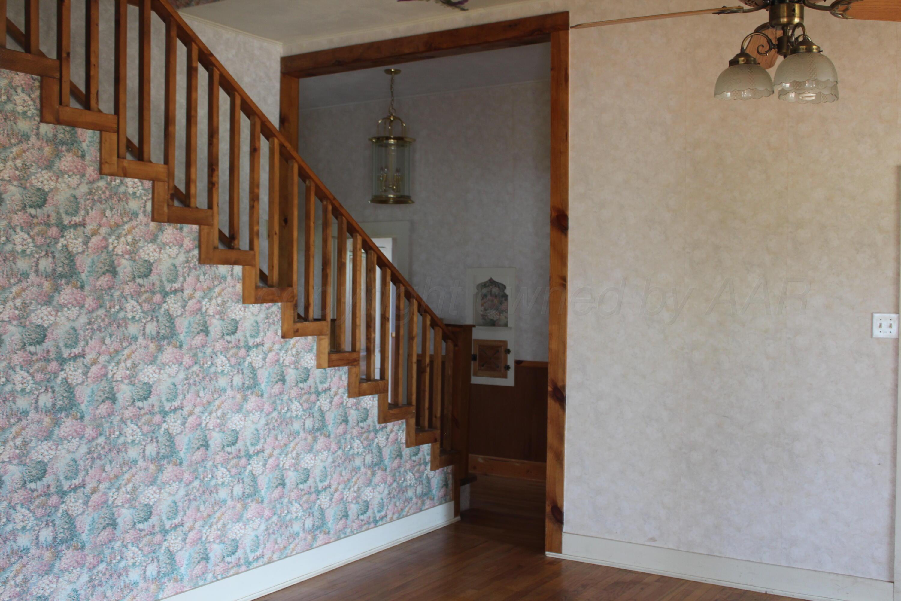 14330 Broome Road Memphis, TX 79245 - Photo 42 of 63 a view of a hallway with wooden floor and staircase
