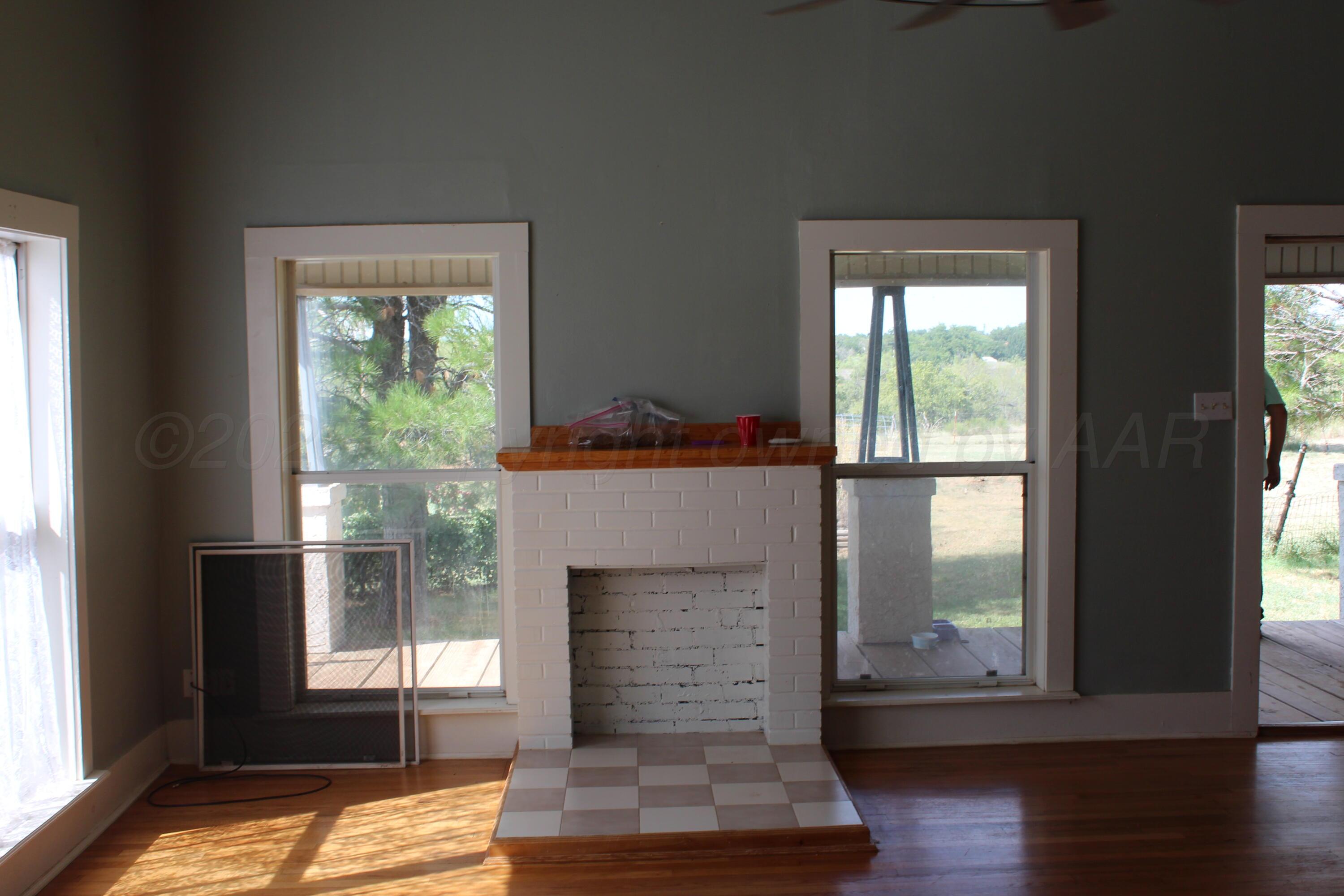 14330 Broome Road Memphis, TX 79245 - Photo 46 of 63 a living room with furniture and a fireplace