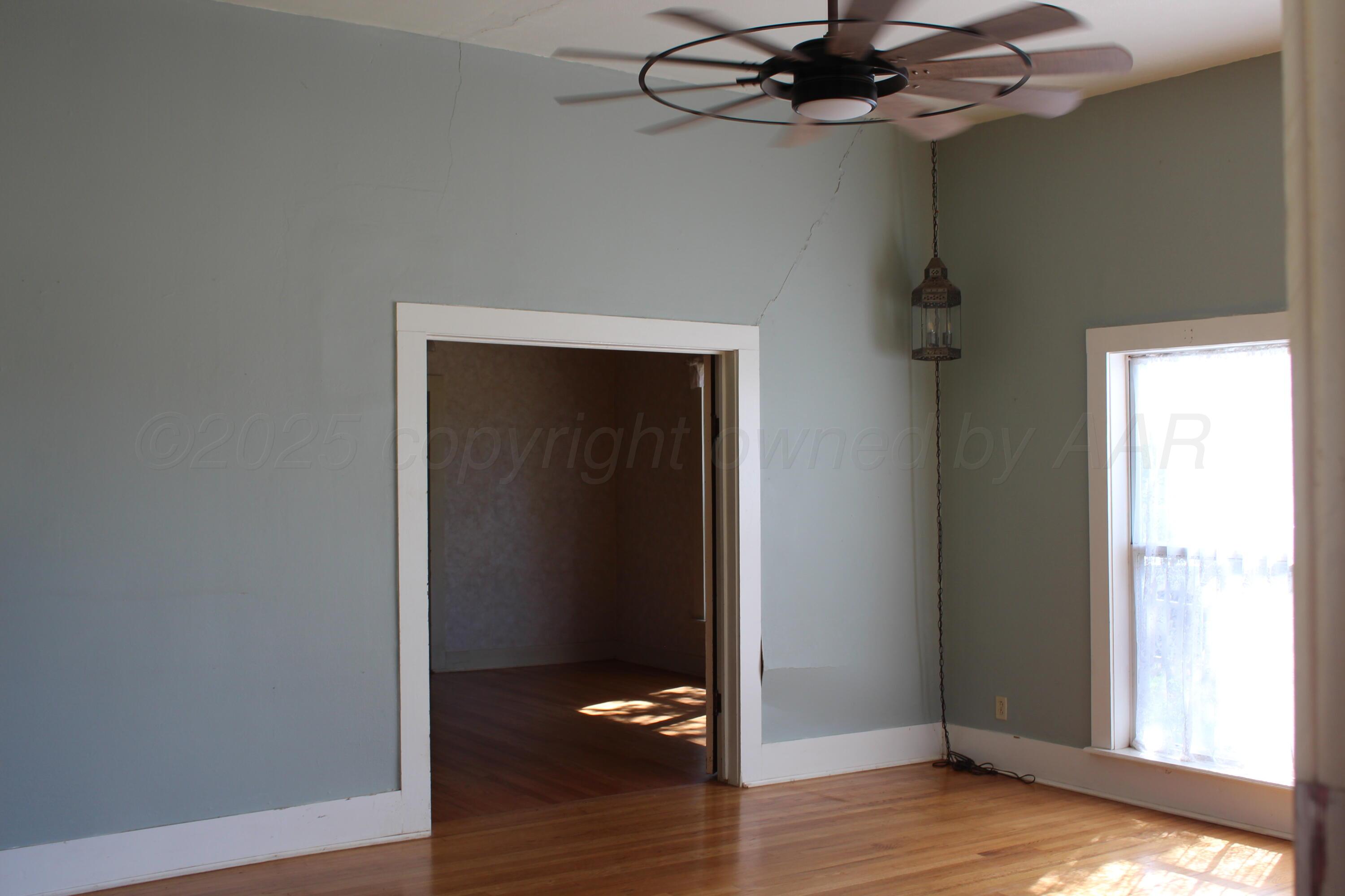 14330 Broome Road Memphis, TX 79245 - Photo 47 of 63 a view of a room with a wooden floor and a ceiling fan