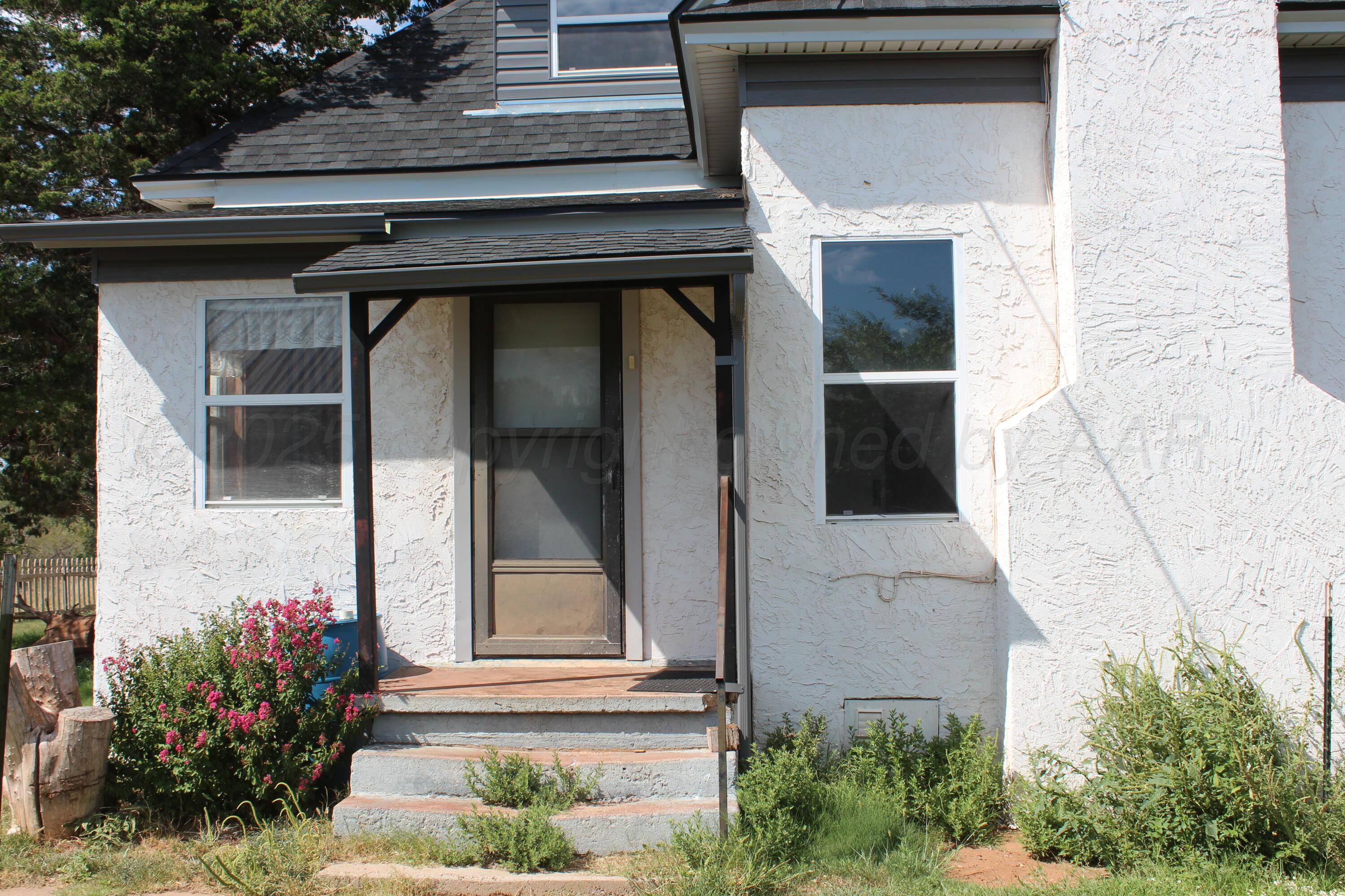 14330 Broome Road Memphis, TX 79245 - Photo 55 of 63 a front view of a house with a garden