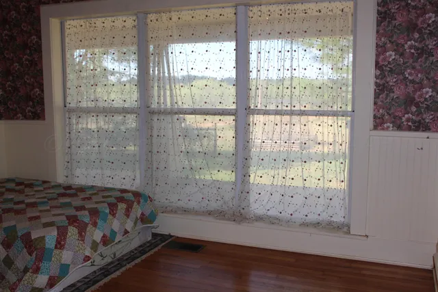 a bedroom with a bed and a window