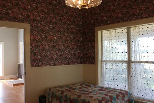 an empty room with wooden floor and closet