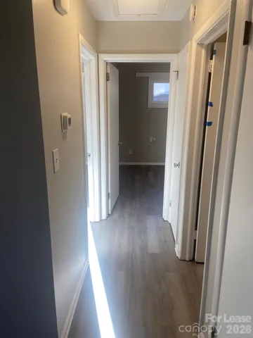 a view of a hallway with wooden floor